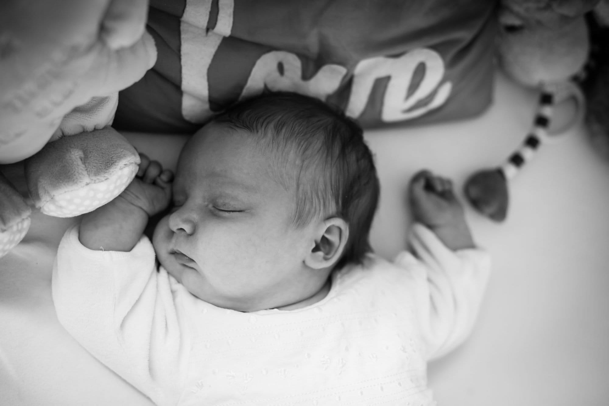 Baby sleeping in cot in newborn photoshoot in Beckenham