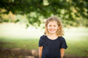 Smiling girl in outdoor park taken by London family photographer