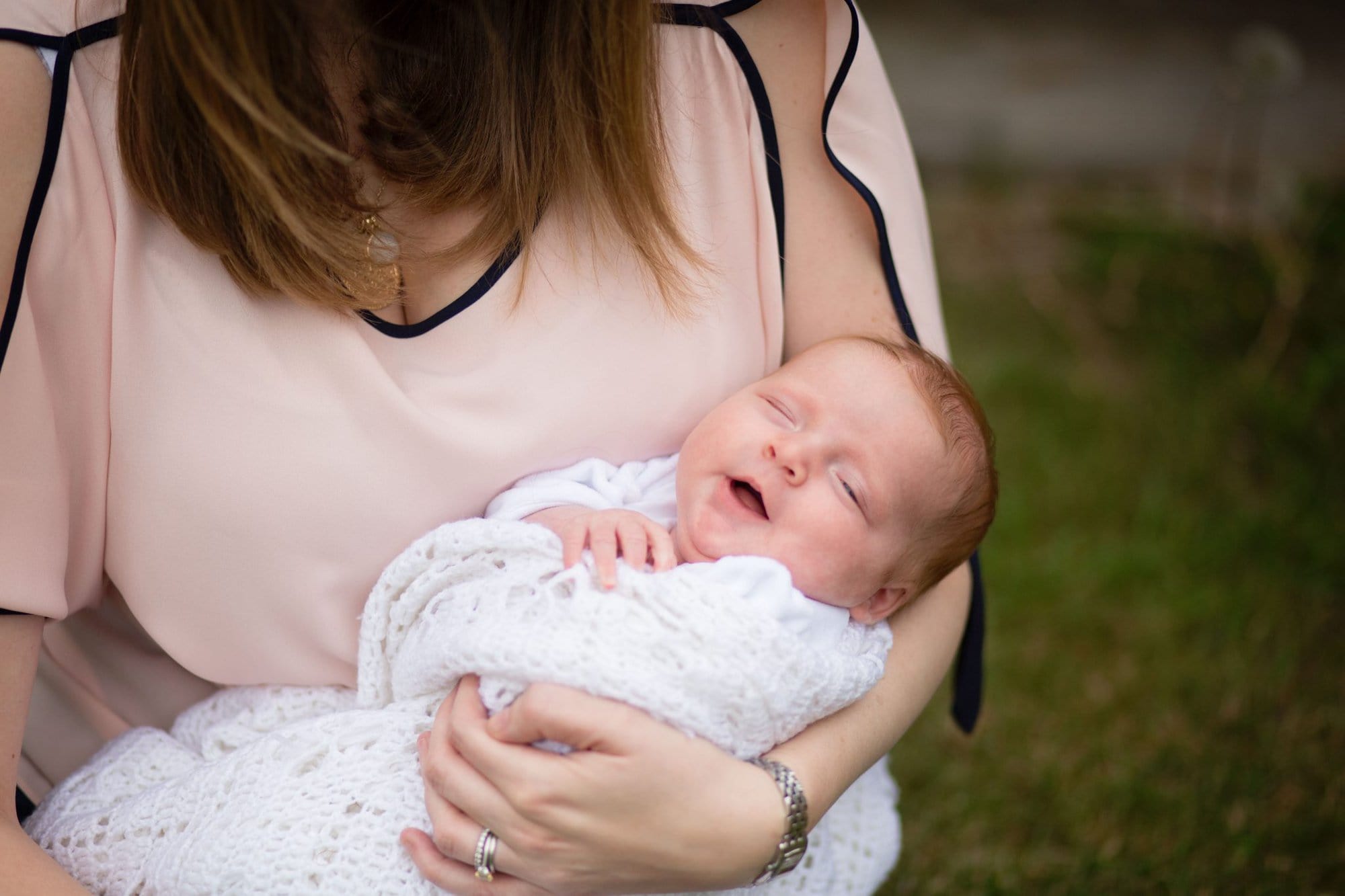 Baby resting in mothers arms in natural newborn photo shoot in London