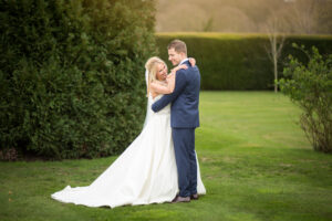 Couple in grounds of Oaks Farm Weddings on their wedding day taken by Surrey Wedding photographer