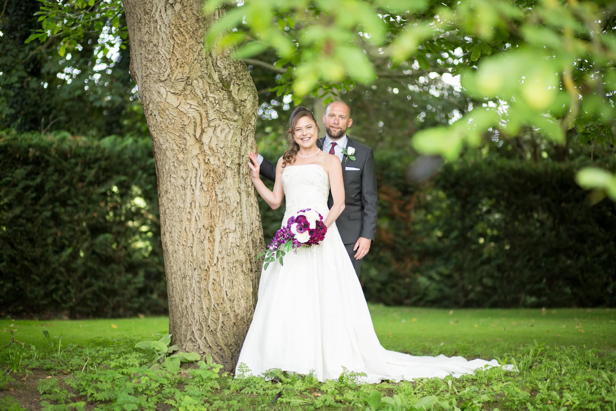 Couple posing by tree at Oaks Farm Wedding venue