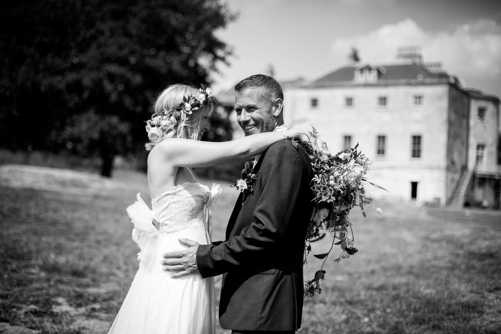 Groom smiling in wedding photo in Beckenham Place Park taken by Bromley wedding photographer