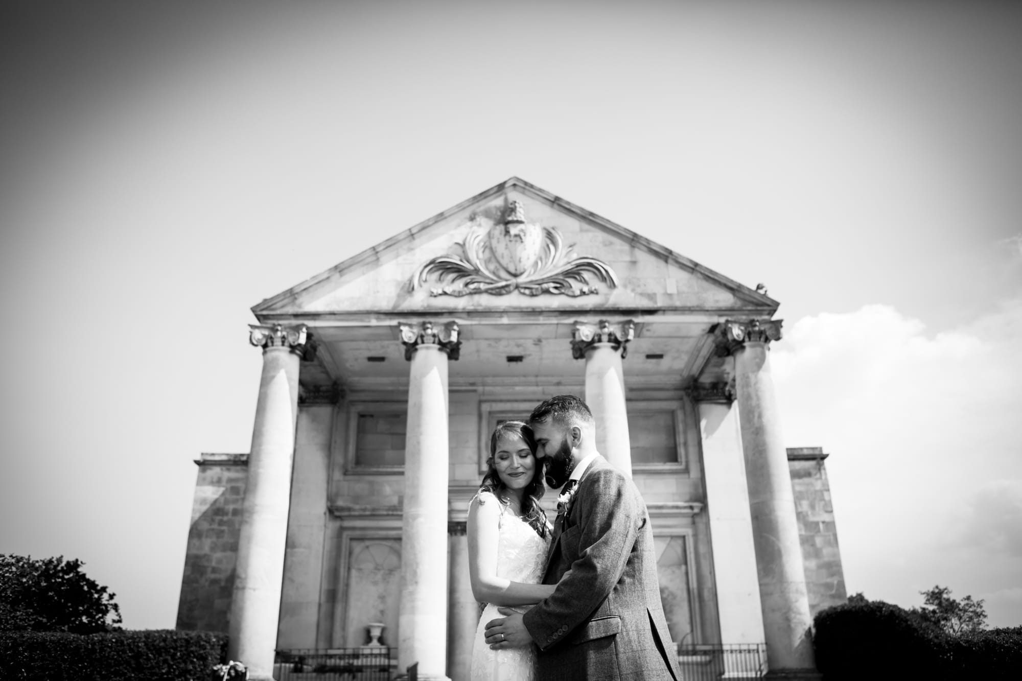 Black and white bromley wedding photography image of couple cuddling outside Beckenham Place Mansion