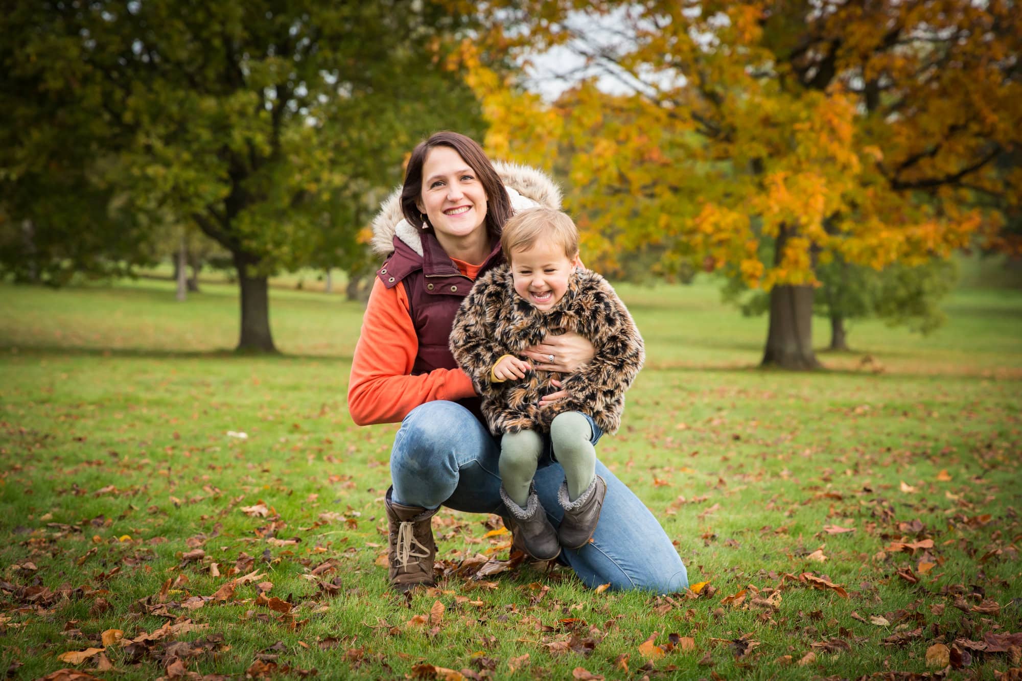 Mum and daughter giggling in photo in autumn in Beckenham Place Park
