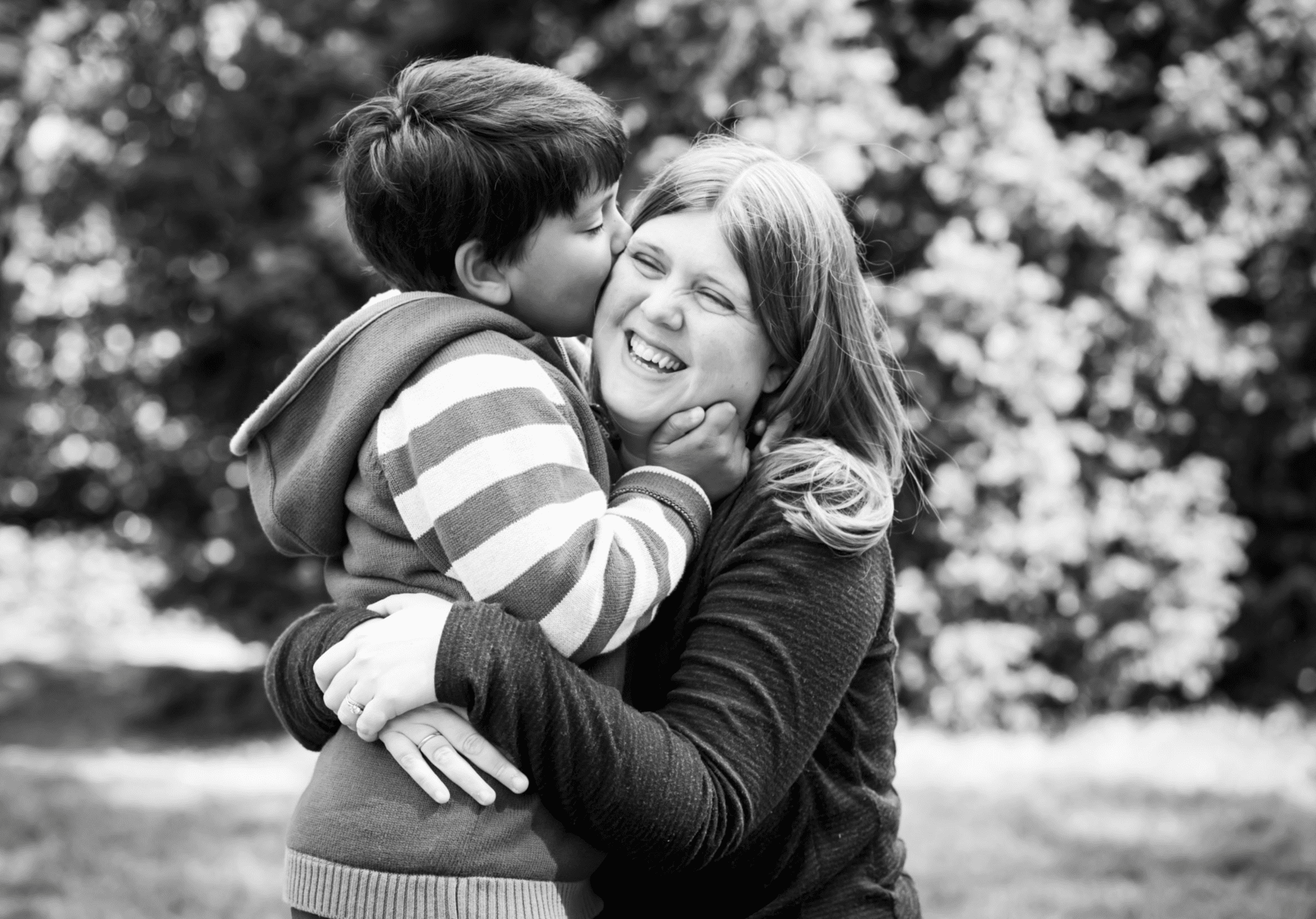 Mum and son cuddling in black and white photo outside taken by Bromley Photographer