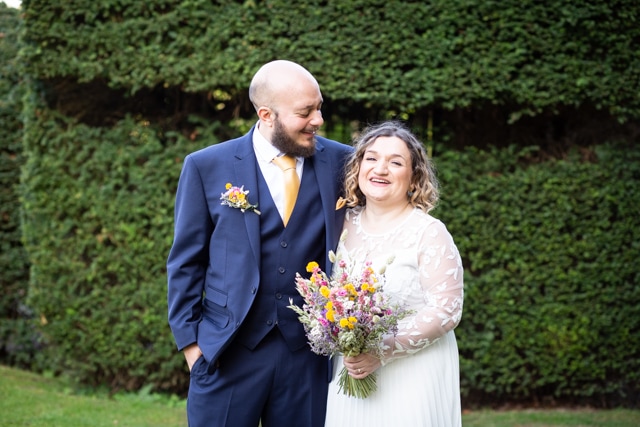 bride and groom smiling in photo at Oaks Farm wedding staken by Bromley wedding photographer