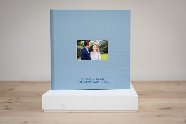 Wedding photography album front cover in pale blue of bride and groom on cover