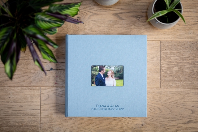 Wedding album front cover in pale blue with bride and groom on cover taken by wedding photographer in Beckenham