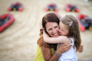 Mum and daughter cuddles on beach in St Ives