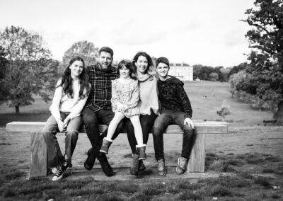 Family sat on bench in black and white Bromley photo outside