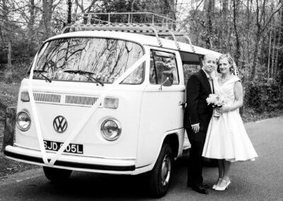 Bromley wedding photography image of couple leaning against campervan wedding vehicle in Keston