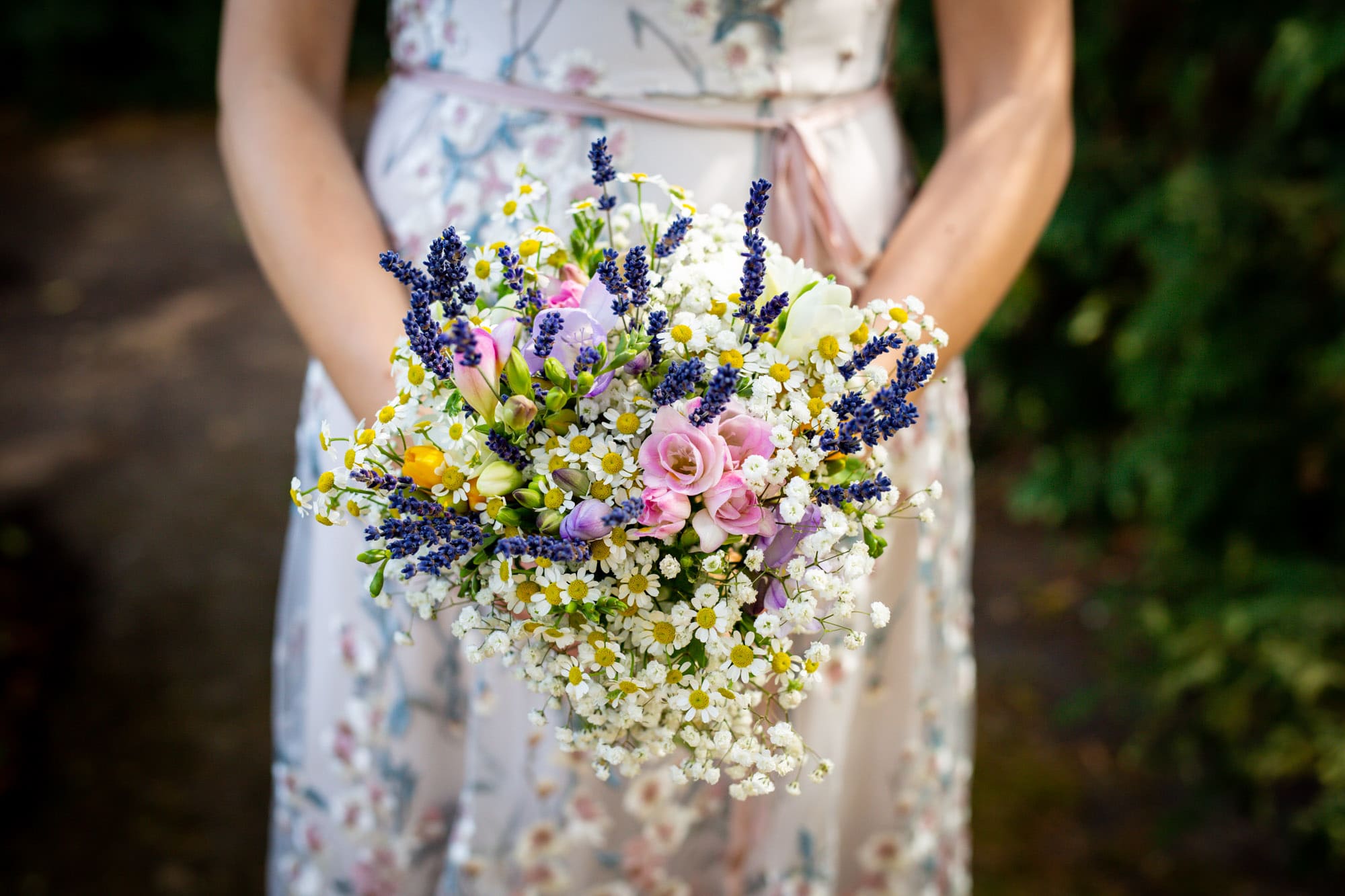 close up of bridal bouquet with daisies and lavender