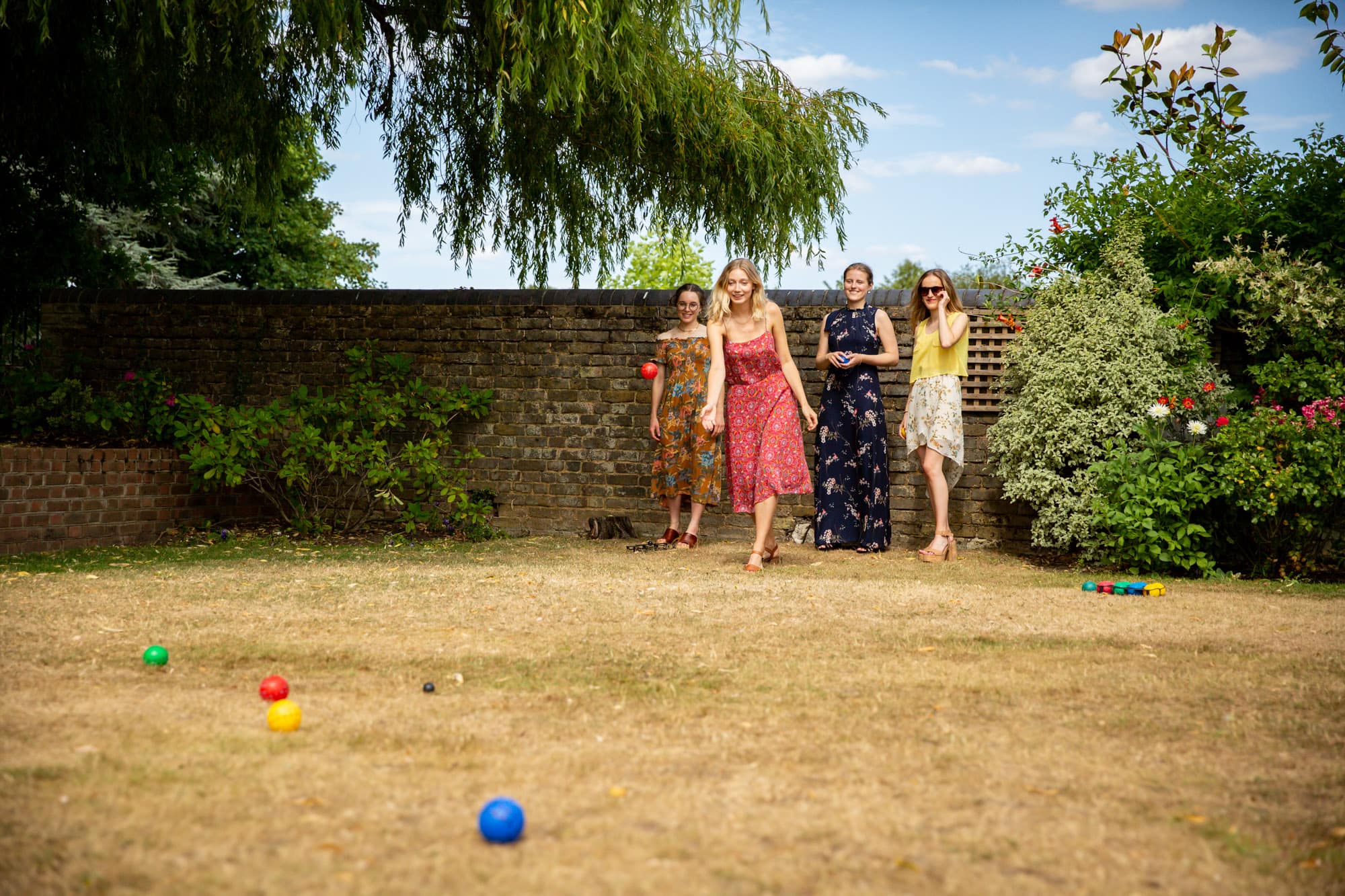 Guests playing boules on grass at wedding at Oaks Farm Weddings