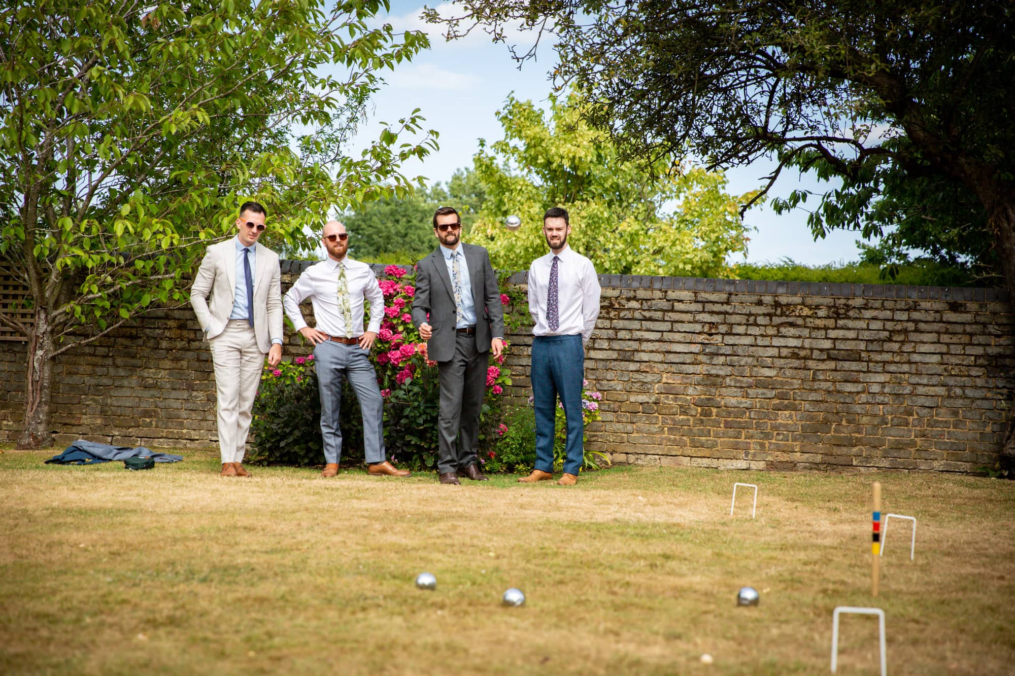 Guys playing boules on grass at Oaks Farm Weddings