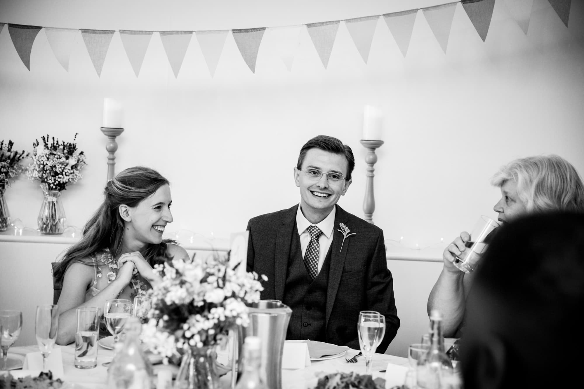 bride and groom in black and white photo at Wedding reception at Oaks Farm Weddings by Bromley wedding photographer