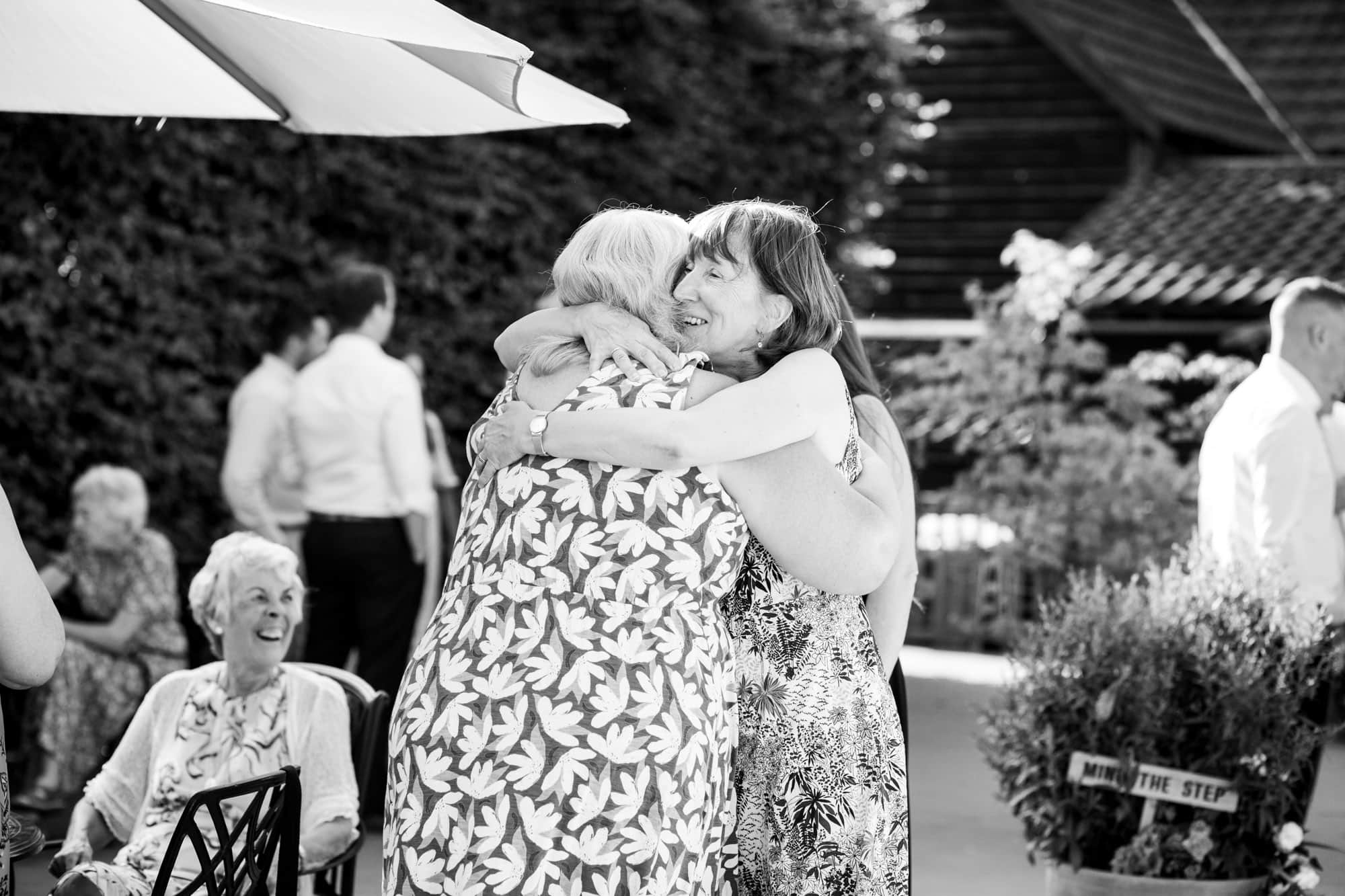 Mums hugging in black and white wedding photoshoot in Bromley